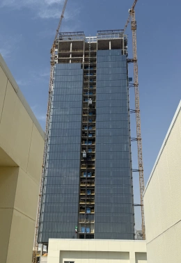 High-rise building under construction with cranes